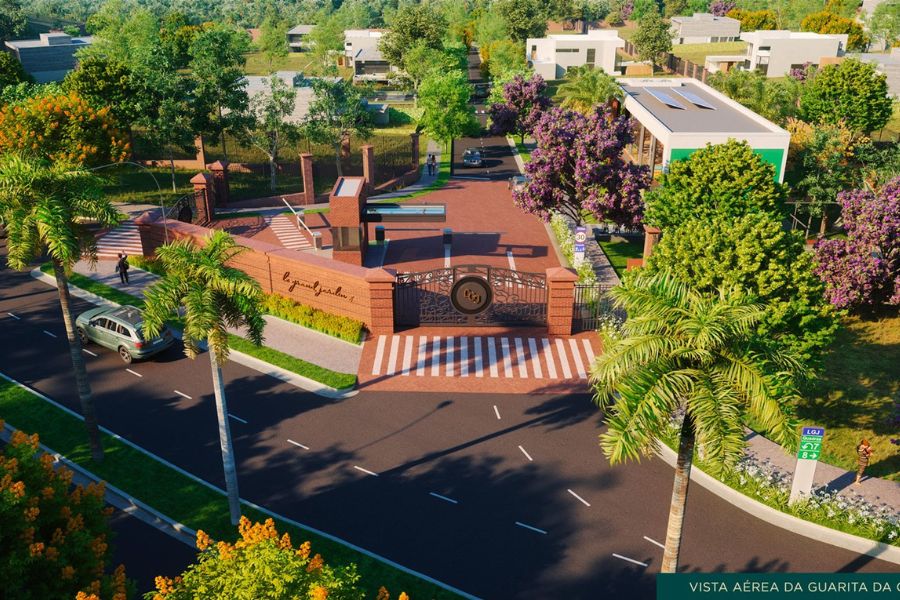 Vista aérea da portaria do condomínio Le Grand Jardin, mostrando guarita, portal principal e áreas verdes ao redor.